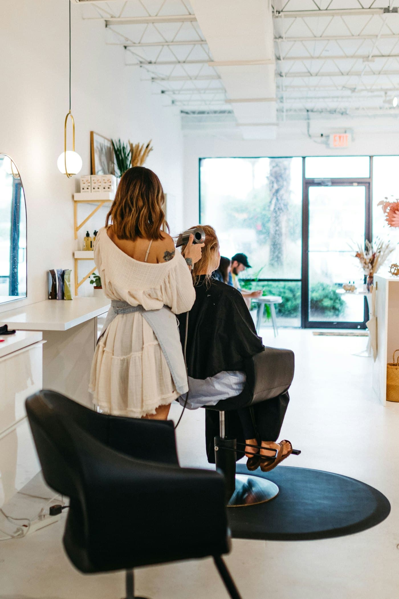 Stylist finishing a client's hair